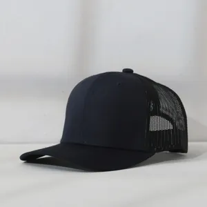 Detailed side view of a navy blue mesh trucker cap showing breathable back texture