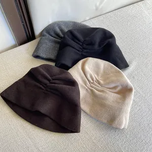 Close-up view of elegant pleated Australian wool beanies in four neutral colors