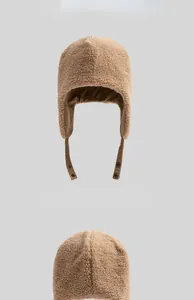 Detailed view of winter faux shearling trapper hat with warm ear flaps and corduroy lining.