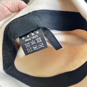 Detail view of the wash care label on a 100% premium wool women's winter bucket hat