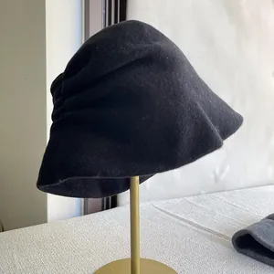 Detailed close-up showing the elegant pleated design of a black Australian wool bucket hat