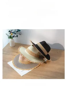 Stacked retro color-blocked straw hats with frayed edges and wide flat brims