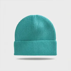 Front view of a teal ribbed knit beanie with a wide cuffed brim on a grey background