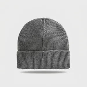 Detailed close-up of a grey ribbed knitted beanie with a classic fold-over cuff design.