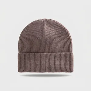 Close-up of professional ribbed knit texture on a taupe winter beanie hat with fold-over cuff