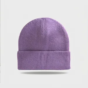 Close-up detail showing the purple ribbed knit texture and folded cuff of a winter beanie.