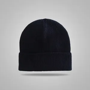 Close-up of a dark navy knitted beanie with a classic cuffed design and ribbed texture