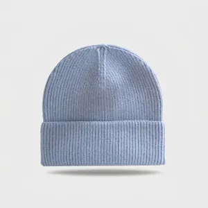 Detailed macro view of a light blue knitted beanie hat featuring a soft textured ribbing