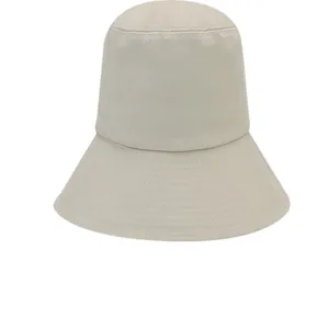 Detailed front view of the beige bucket hat showing its structured crown and stitched brim