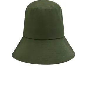 Close-up macro view of the stitched wide brim on a minimalist olive green bucket hat