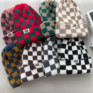 A collection of stylish checkerboard pattern knitted beanies in multiple vibrant colors.
