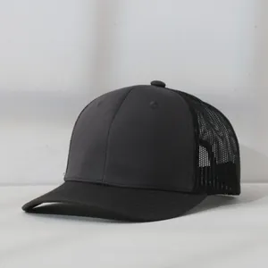 Detail view of a black mesh trucker baseball cap with a breathable back