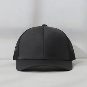 Close-up front view of a minimalist black mesh back trucker hat with a curved brim.