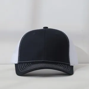 Front view of a high-quality navy blue and white mesh trucker cap with curved brim