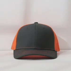 Front view detail of a charcoal grey and orange mesh trucker hat with contrast stitching