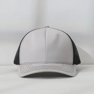 Front view detail of a two-tone mesh trucker hat in grey and black.