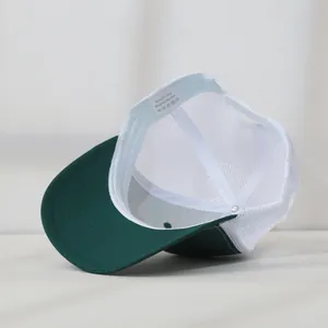 Detail view of the interior and wash label of a green and white mesh trucker hat