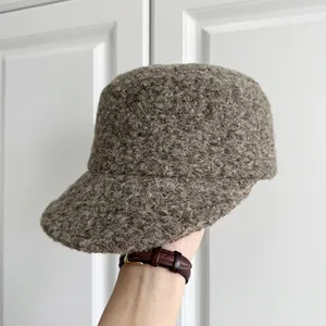Close-up of a thick wool bucket hat with a cozy textured finish in grey-brown