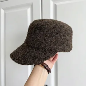 Detailed macro view of a dark brown textured wool bucket hat for winter fashion