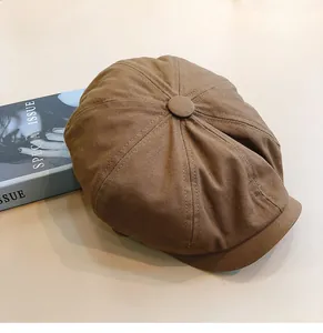 Detailed top view of a brown vintage newsboy hat with stitched octagonal panels