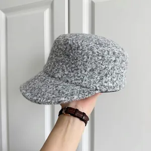 Close-up detail of the gray thick wool textured cloche hat showing the fuzzy winter fabric