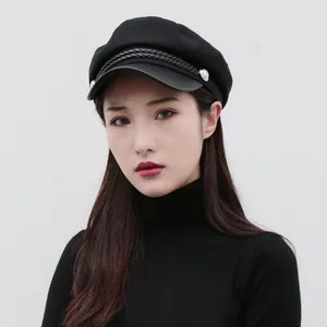 Classic black flat top newsboy hat for women featuring a stylish braided rope detail