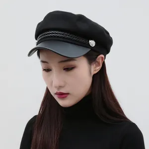 Classic black flat-top newsboy hat for women featuring braided band and stylish leather brim