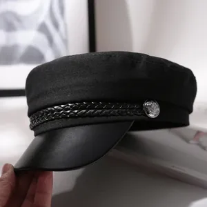 Classic black newsboy cap for women featuring a braided cord and leather-like brim detail