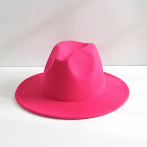 Close-up detail of a stylish magenta pink wool fedora hat with a wide brim for fashion
