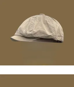 Side view of a vintage khaki cotton newsboy cap showing fine stitching and texture