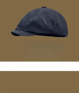 Side view of a vintage navy blue newsboy cap showing stitching and fabric texture