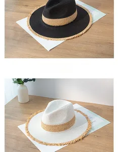 Detailed view of women's vintage straw sun hats with frayed edges in black and white