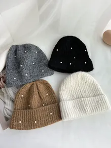 Set of warm winter knit beanies in four colors featuring elegant pearl embellishments