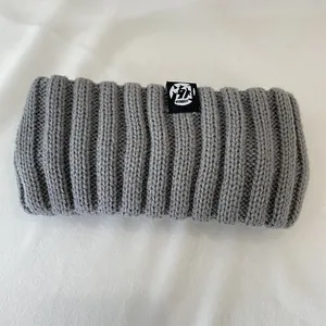 Close-up of grey vintage wide elastic knitted headband for winter warmth and style.