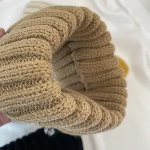 Close-up detail showing the thick ribbed texture of a warm knitted winter headband.