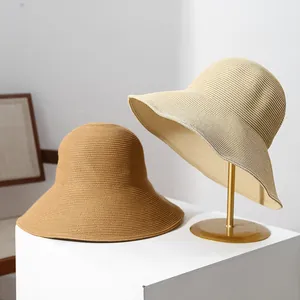 Two stylish wide-brim straw sun hats for women displayed in khaki and beige colors