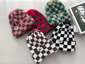 Detailed view of thick checkered knit beanies in various stylish colors for autumn and winter