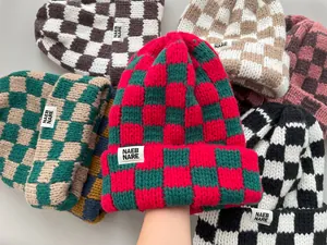 Collection of thick checkered knitted beanies showing various colors and textures