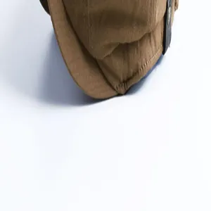 Close-up detail of a vintage brown newsboy hat brim showcasing high-quality stitching