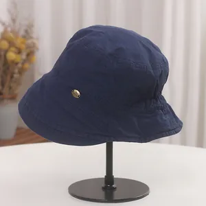 Detail view of a vintage pleated navy bucket hat for women with foldable cotton fabric.