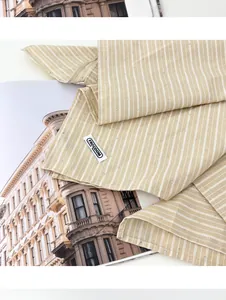 Detailopname van een gestreepte vintage beige bandana met zilveren studs en geweven label