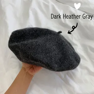 Close-up detail of a dark heather gray wool beret showing its soft felted texture.