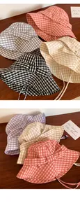 Assorted colors of gingham bucket hats featuring bow ties and wide brims for sun protection