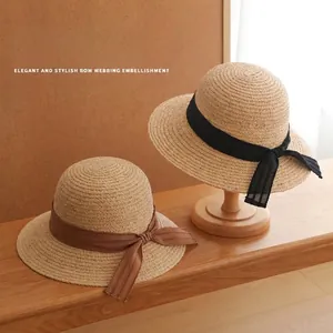 French vintage straw sun hat with elegant bow ribbon decoration for summer beach