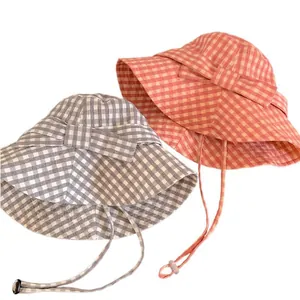 Stylish plaid bucket hats with decorative bows and adjustable chin straps for women