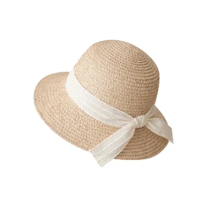Elegant French vintage straw sun hat with a decorative white ribbon bow for beach travel