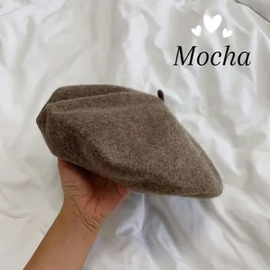 Detail view of a classic mocha brown solid color wool beret for women in autumn