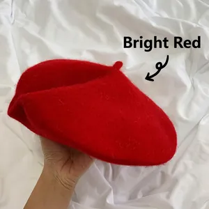 Detail of bright red wool beret showing soft knitted texture and classic design