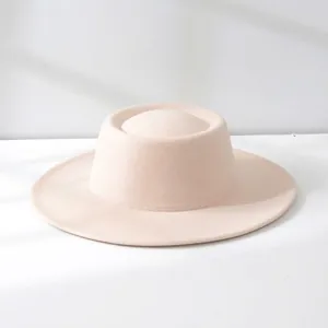 Macro view of a stylish beige wool felt jazz hat featuring a flat top and wide brim