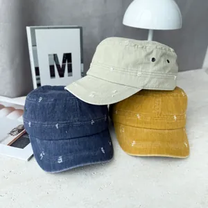Detailed view of three distressed cotton military cadet caps in blue, khaki, and yellow